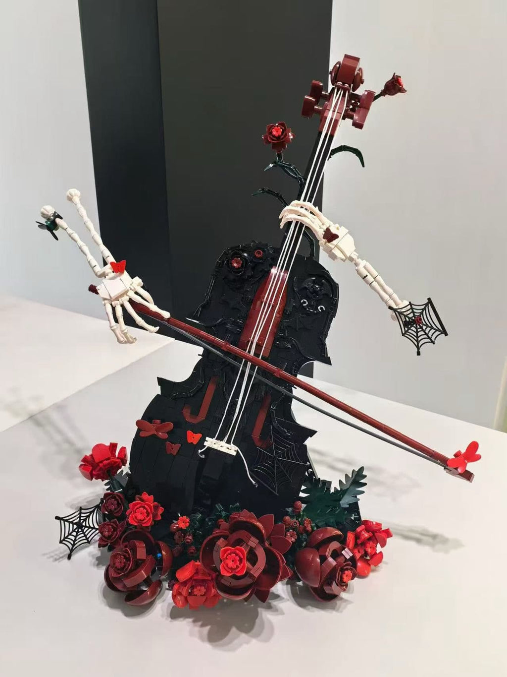 Dark aesthetic cello building set with black body, red flowers, and gothic decor details